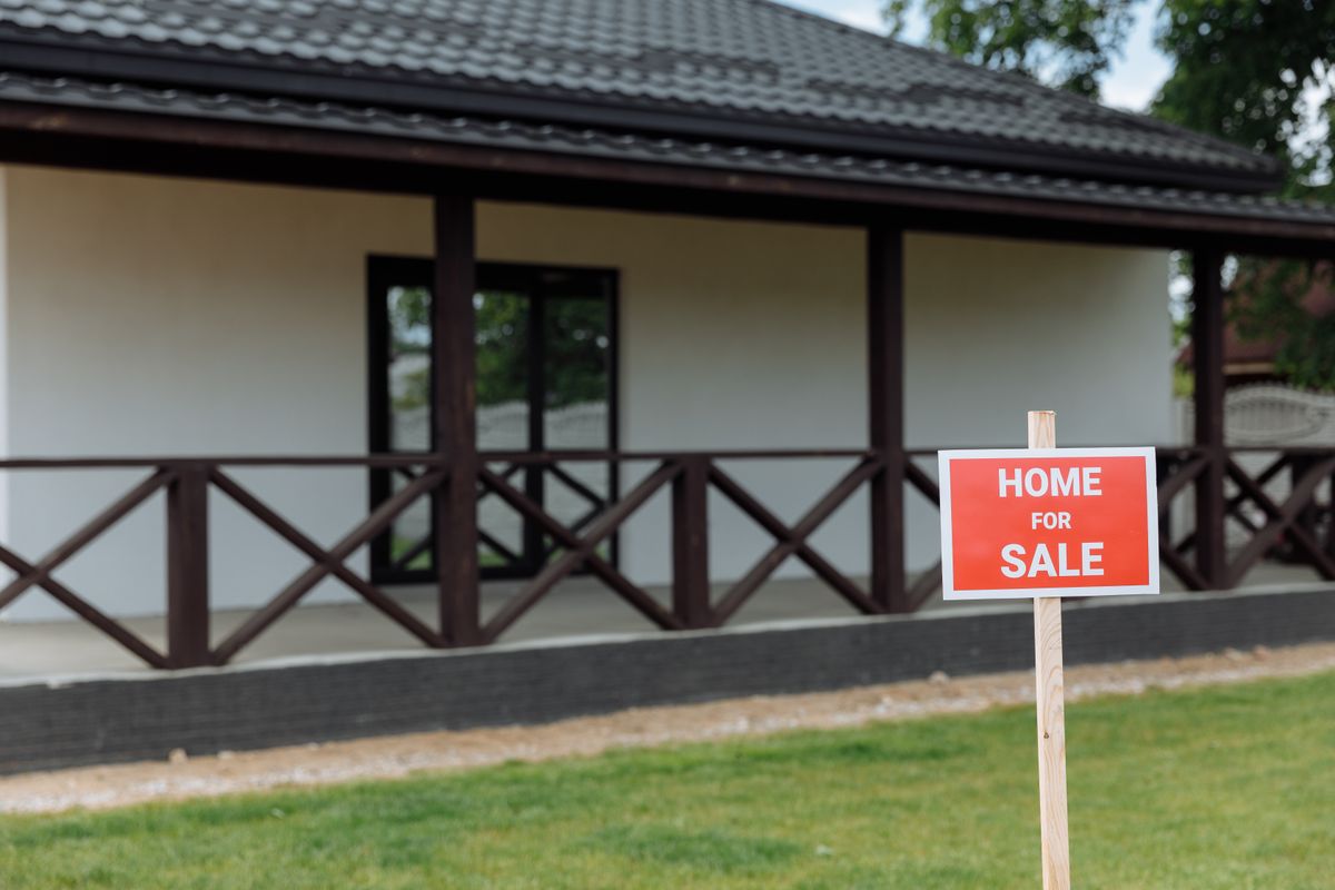 A Home for Sale sign in front of a house