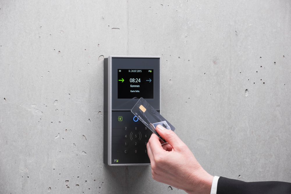 A person using a card reader at a secured entrance